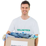 Volunteer carrying a box of donated clothing represents Phoenix Innovate�s culture of giving back