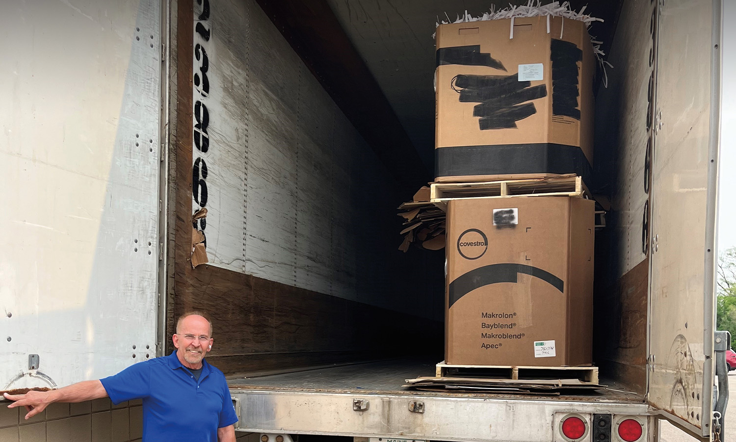 Gary Athan, Delivery Administrator at Phoenix Innovate in Troy, stands beside the bed of a truck filled with materials to be recycled.